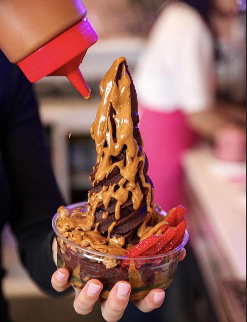 Signature Biscoff açaí bowl with sauces and strawberries